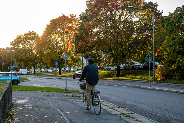 Commuter cycling on a dedicated lane in Skien morning traffic